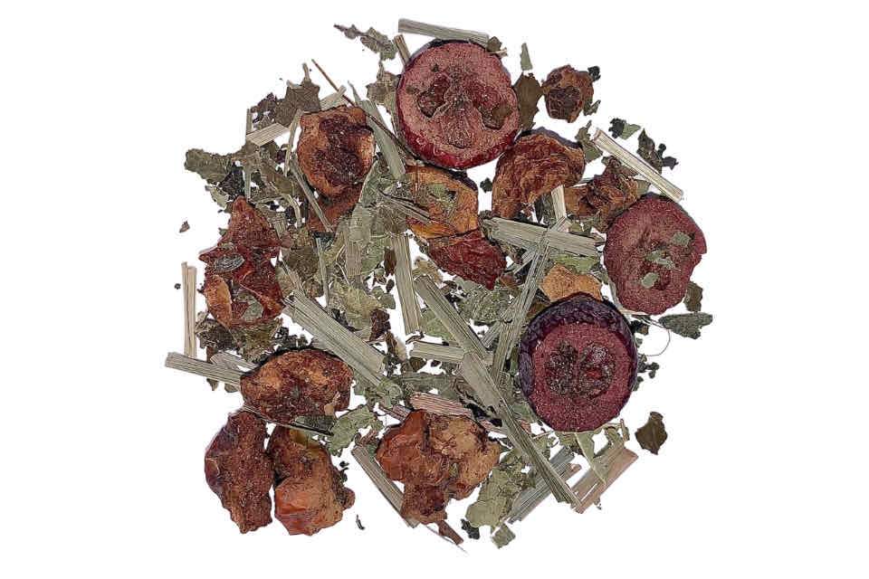 a pile of herbal tea with dried cranberry, acai palm, and raspberry leaves