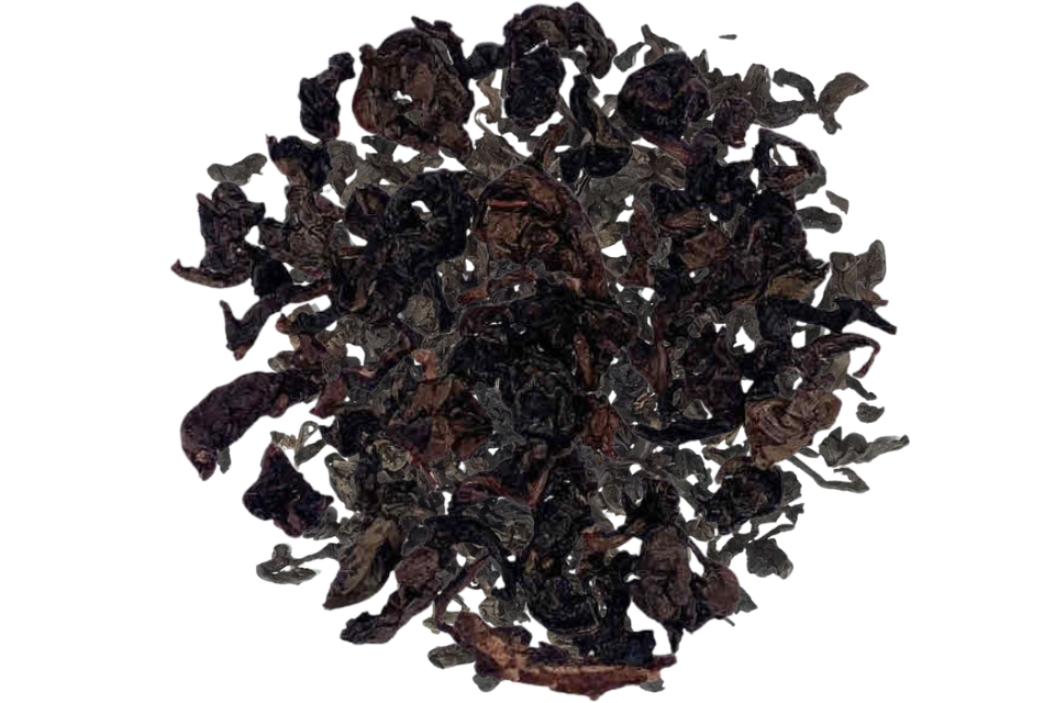 Dry dark brown tea leaves on a white background