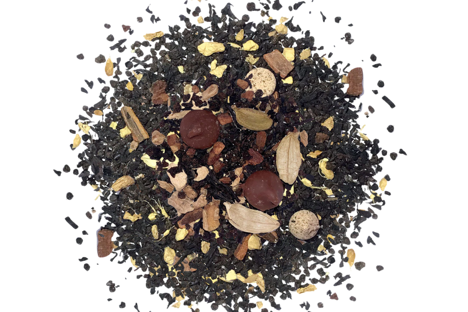 Spice mix including black peppercorns, cardamom pods, and other spices on a white background