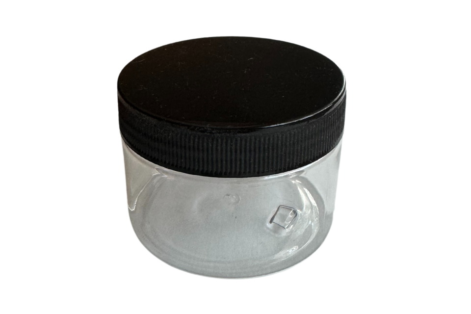 a clear round canister for storage with a black screw top on a white background