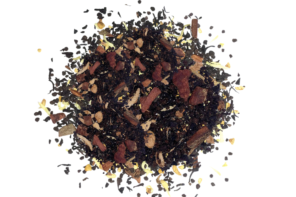 Spice mix including cinnamon sticks and star anise on a white background