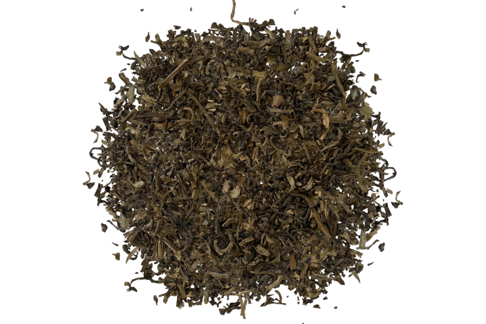 Dry tea leaves on a white background