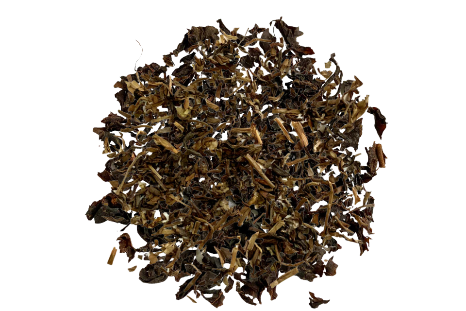 A close-up image of decaf loose leaf tea, primarily consisting of black tea with some lighter leaves included.
