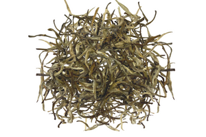 A pile of dried, withered leaves of Darjeeling premium India white tea.