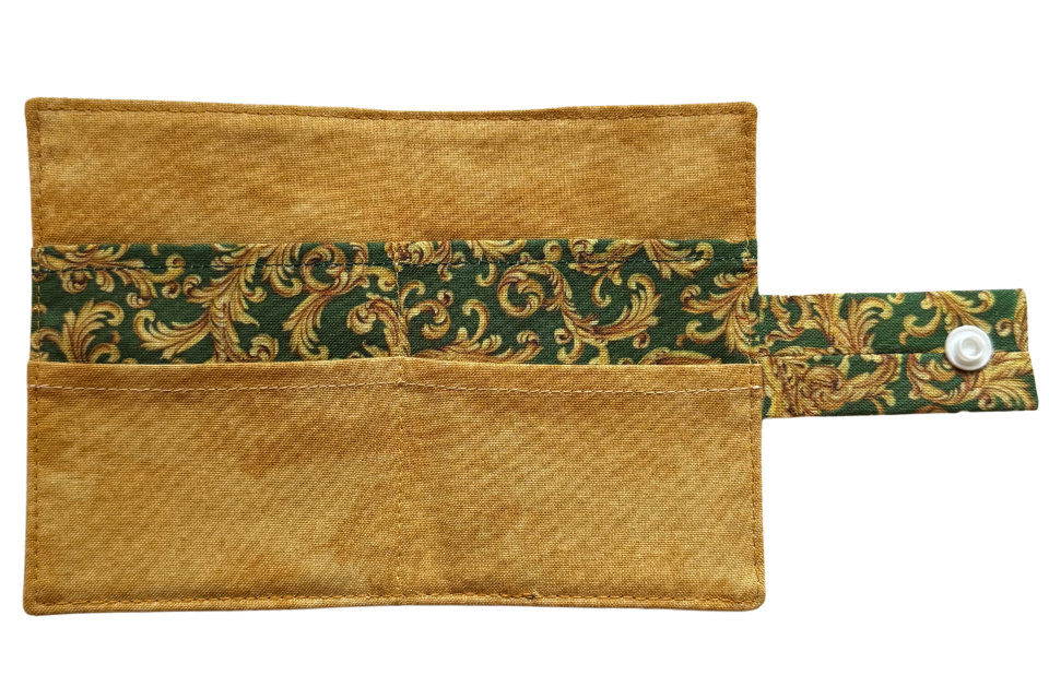 Gold pouch with green floral pattern , 4 compartments, and a snap closure on a white background
