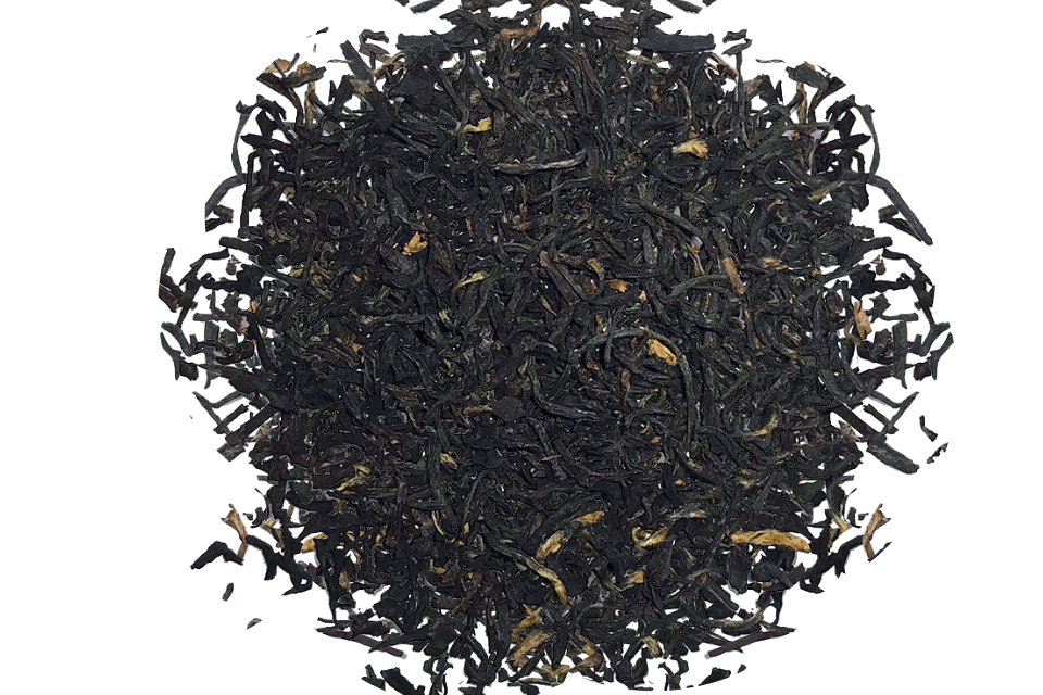 Close-up of black tea leaves on a white background