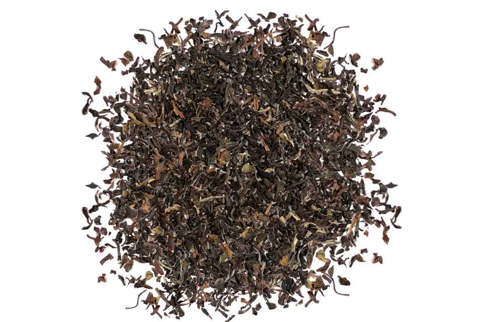 Dry black tea leaves on a white background