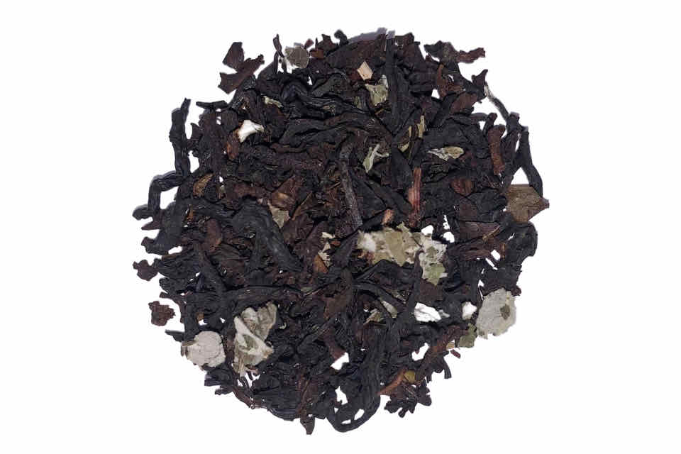 a pile of black tea with blackberry leaves