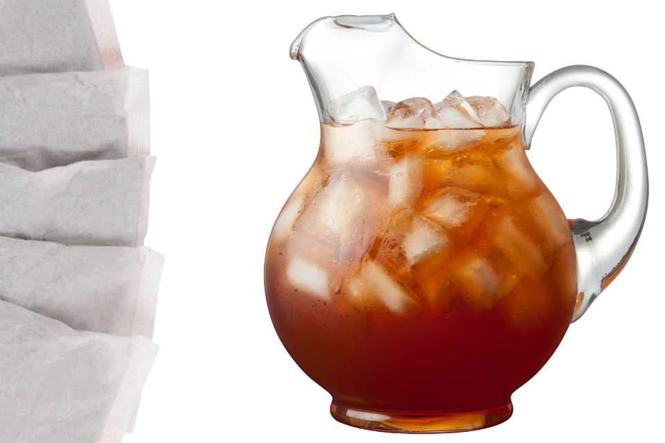 A clear glass filled with black iced tea and a tea bag, indicating the product is a packaged tea product likely designed for brewing iced tea.