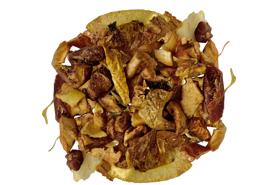 A pile of dried citrus zest tisane tea ingredients including apple pieces, orange slices, and dried flower blossoms.