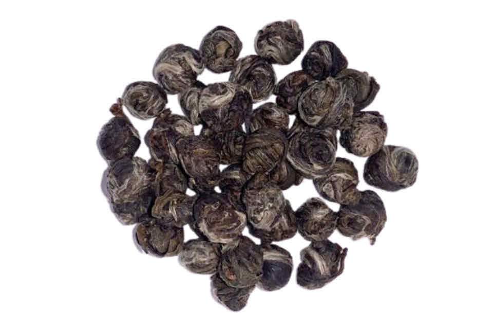 a pile of green rolled dragon pearl tea balls