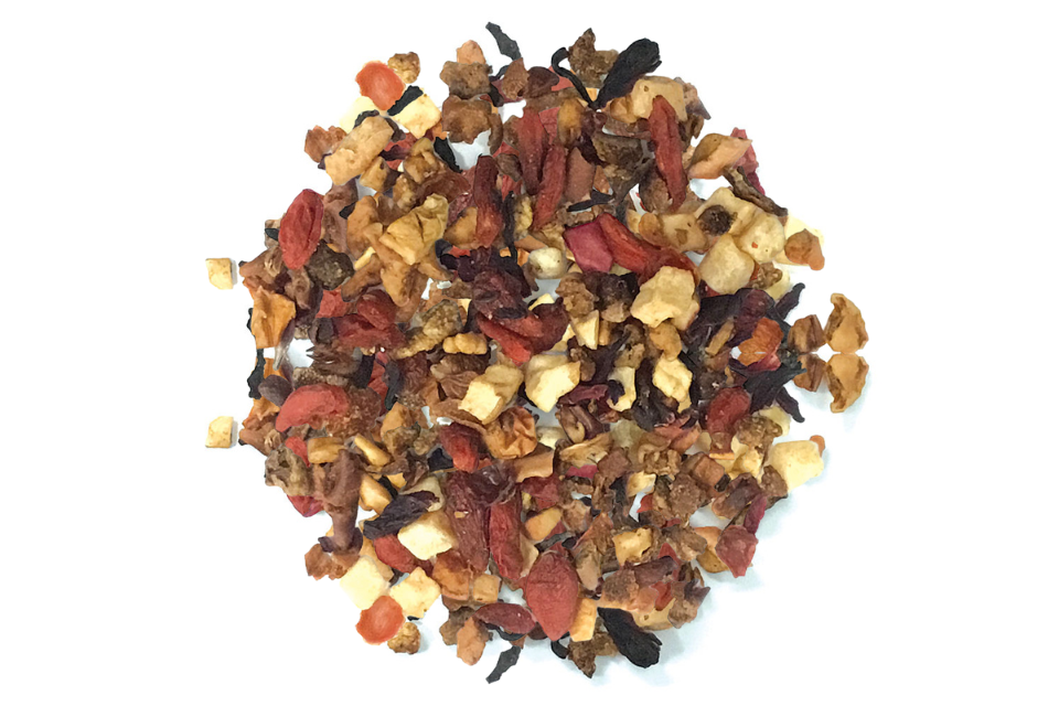 A variety of dried fruit pieces and hibiscus blossoms, indicative of the ingredients in a melon berry bliss tisane tea blend.