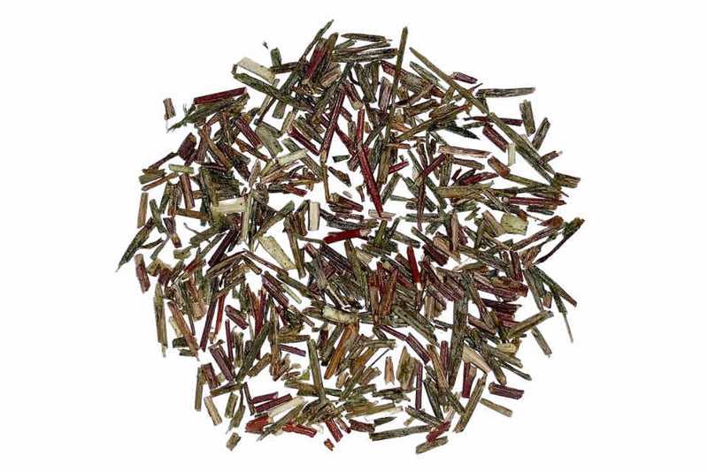 A heap of dried green rooibos leaves.