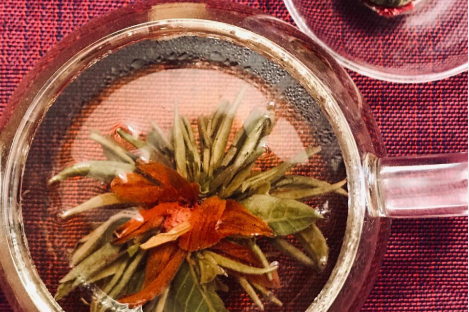 a steeped guava fruit tea ball in a glass teapot