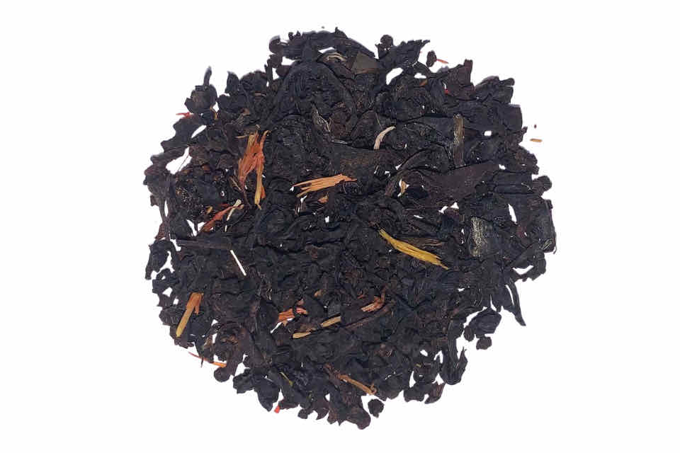 a pile of dark black tea with cherry pieces 