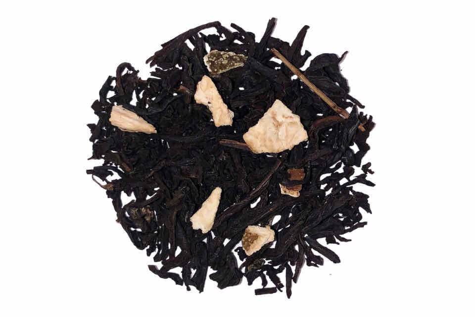 a pile of black tea and dried ginger, cinnamon, and citrus pieces