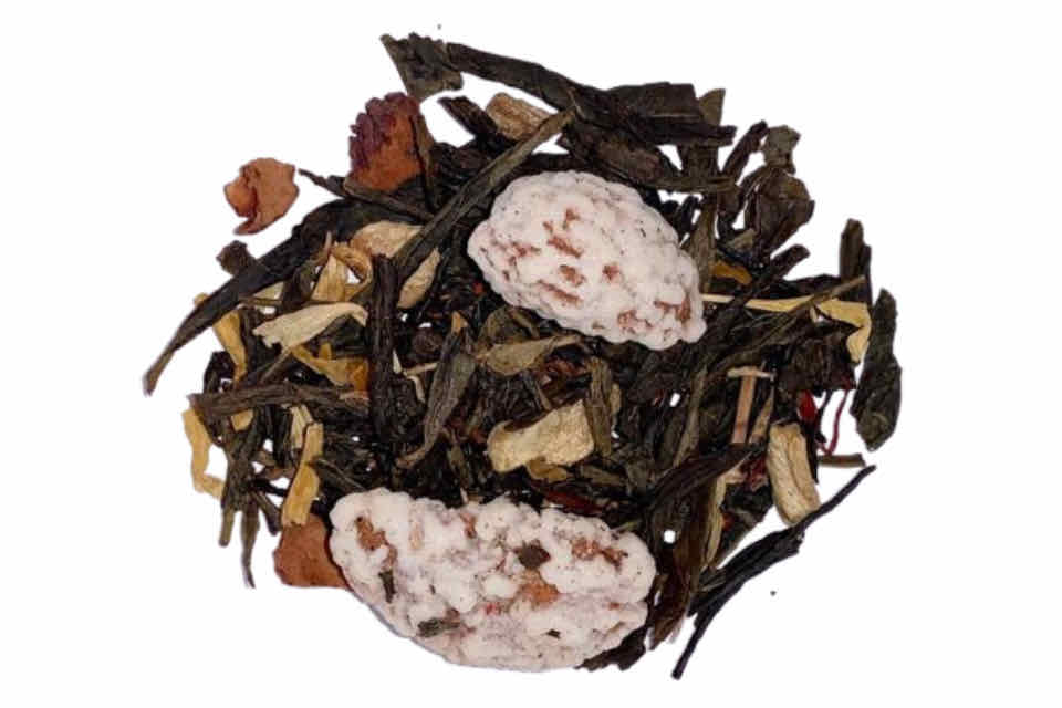 A pile of dried apple ginger green tea ingredients including green tea leaves, dried apple slices, ginger pieces, almonds, marigold flowers, and safflowers.