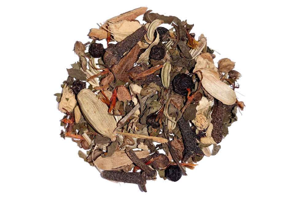 A heaping mix of various dried spices and herbs, commonly used for making Ayurvedic tea.