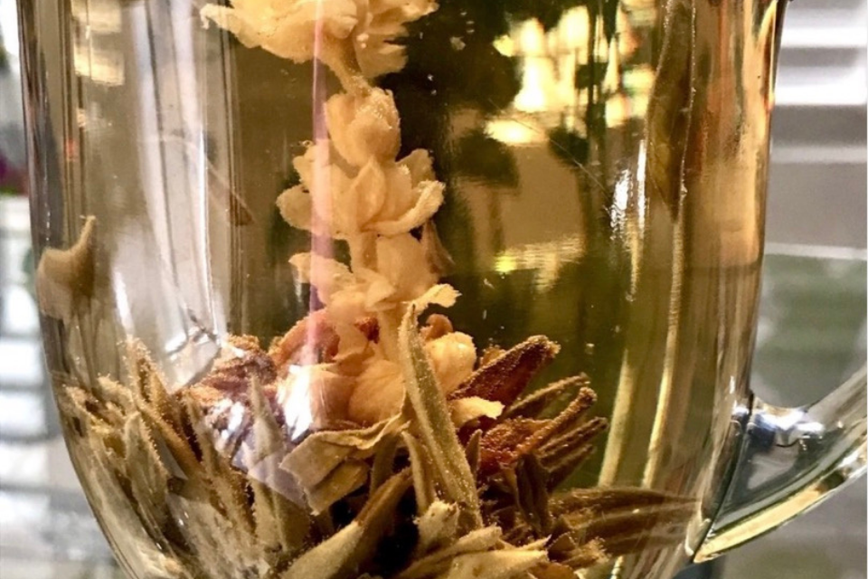 a glass with hand-tied lychee fruit green tea