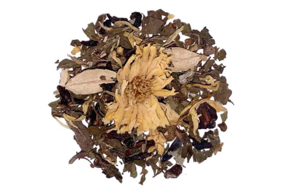 A heap of dried herbal tea ingredients, including chrysanthemum, saffron, marigolds, green cardamom, hibiscus, peppermint, sarsaparilla, raspberry leaves, tulsi, and lemon and peach flavor, against a white background.