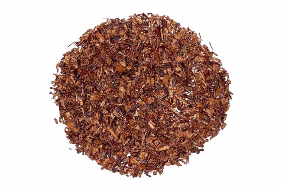 A heap of red rooibos tea leaves.