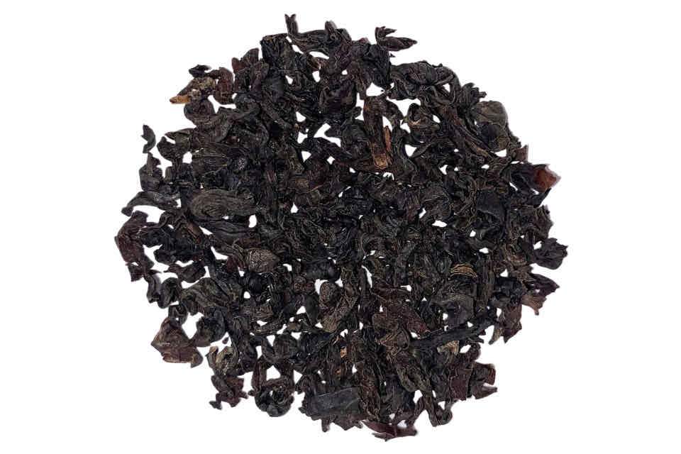 dried black loose leaf tea ruhunu tea on a white background