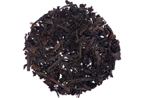 A pile of smoked tea leaves and stems, with a dark brown color and a subtle smoky aroma.