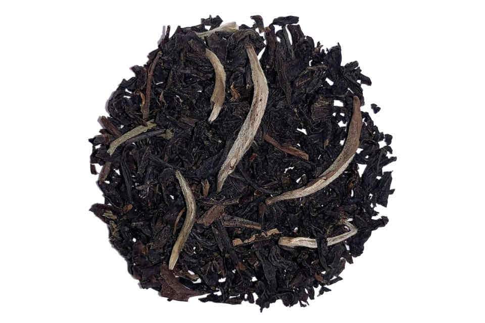 earl grey tea with silver needles on a white background