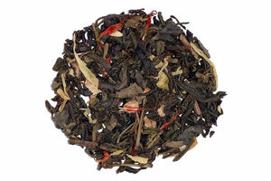 A close-up of Sun-Kissed Ginger Peach Premium Tea leaves, showcasing black tea leaves interspersed with pieces of ginger, orange peels, and marigold petals.