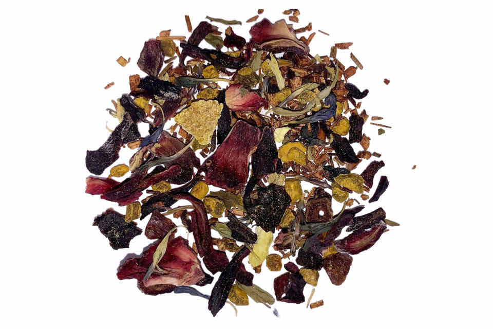 A mixture of dried ingredients including leaves and pieces of fruit typically found in rooibos tea, with a few added for flavoring such as citrus zest and orange peel.