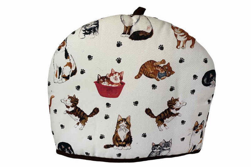 A fabric teapot cozy with a white background featuring various cartoon cats in different positions and a teapot illustration in the center.