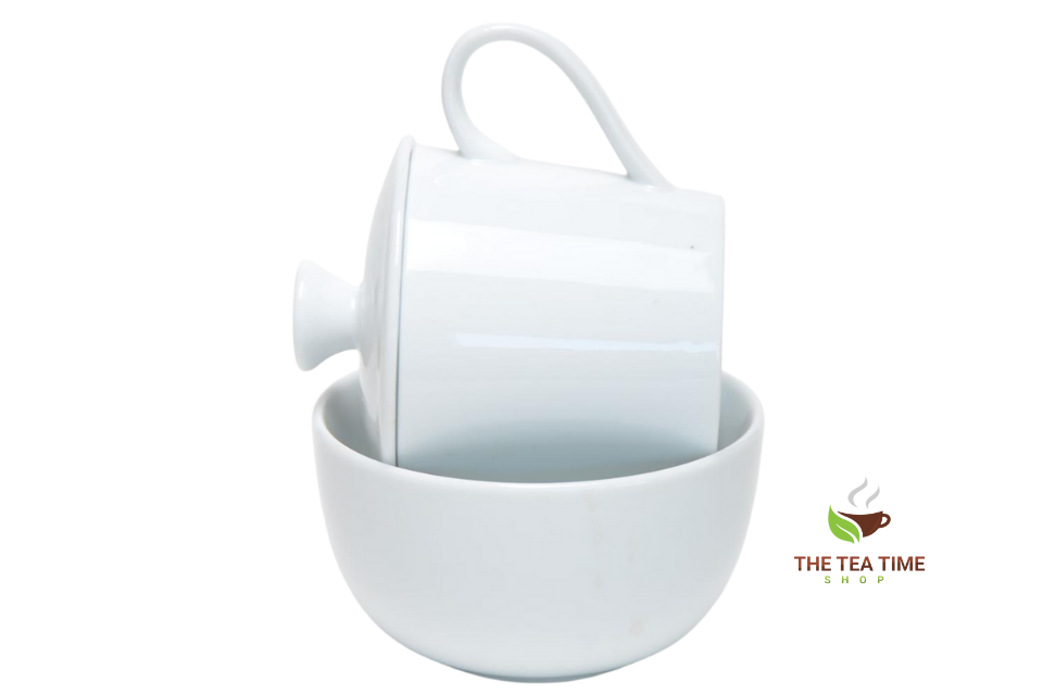 A white porcelain cupping set, including a lid and a bowl, with a logo 'The Tea Time Shop logo' visible in the image.