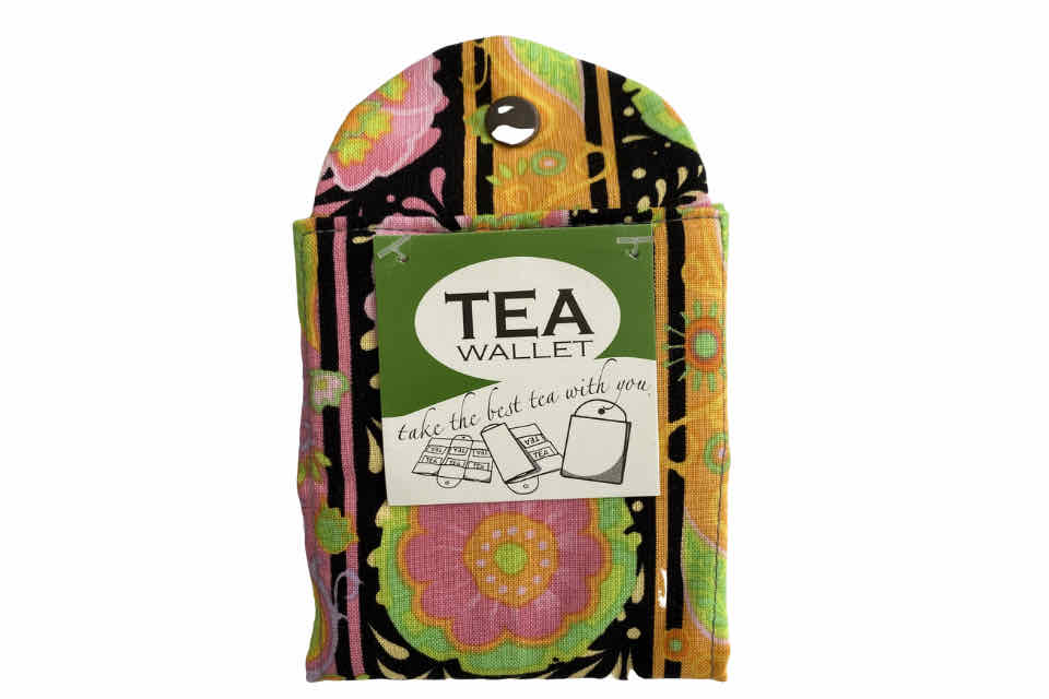 A fabric wallet with a floral pattern on a white background