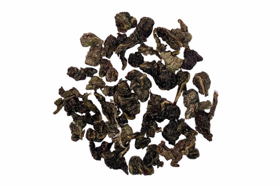 a pileof ti kwan yin oolong tea leaves