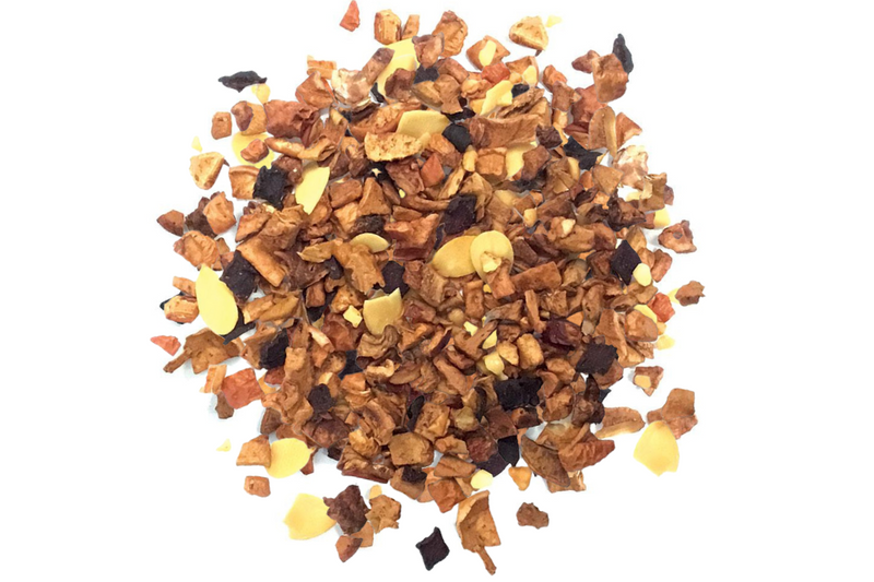 A pile of toasted almond tisane tea with visible pieces of almonds, apple, and beetroot.