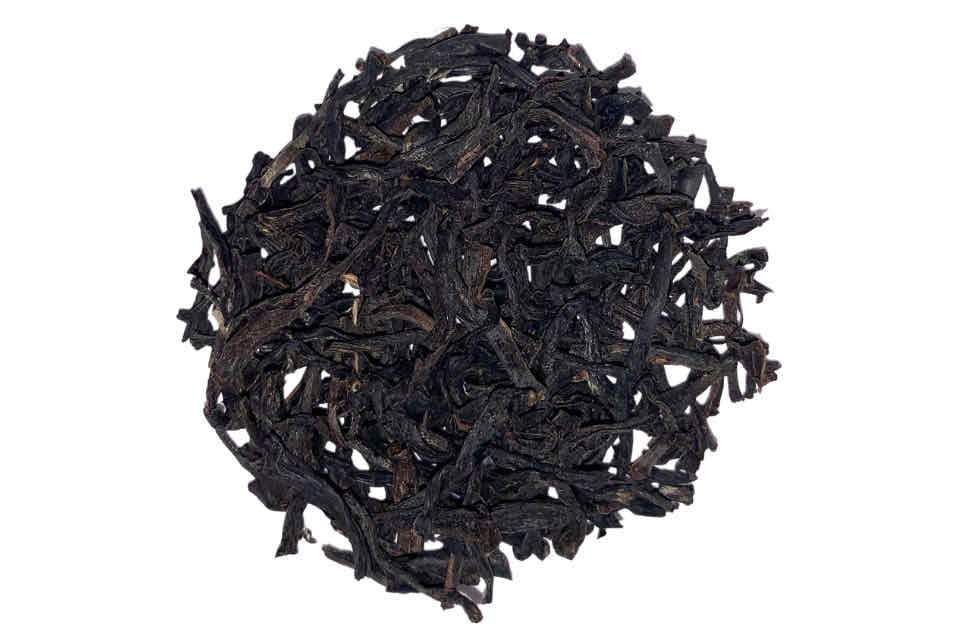 A heap of loose Assam black tea leaves.