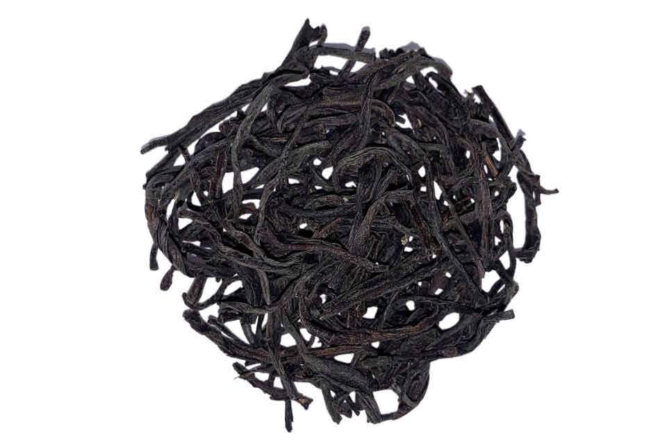 A heap of dark, twisted tea leaves.