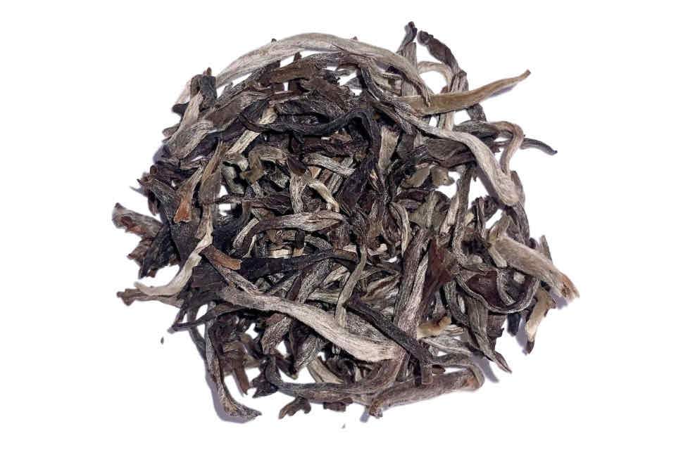 A pile of white tea leaves resembling monkey paws.