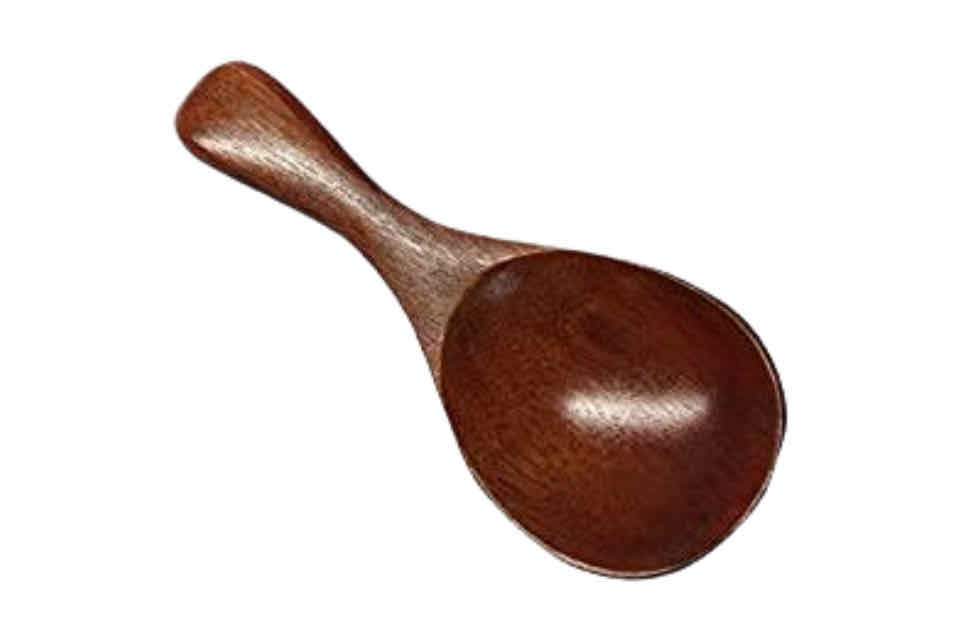 A small wooden tea spoon with a solid handle.