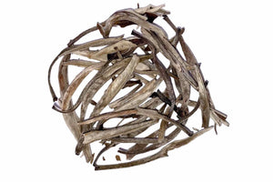 A pile of dry, yin zhen silver needle tea leaves against a white background.